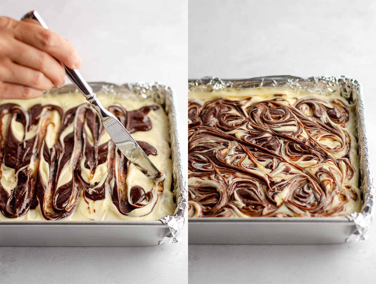 a hand swirling brownie batter into mascarpone cheese layer to make tiramisu brownies