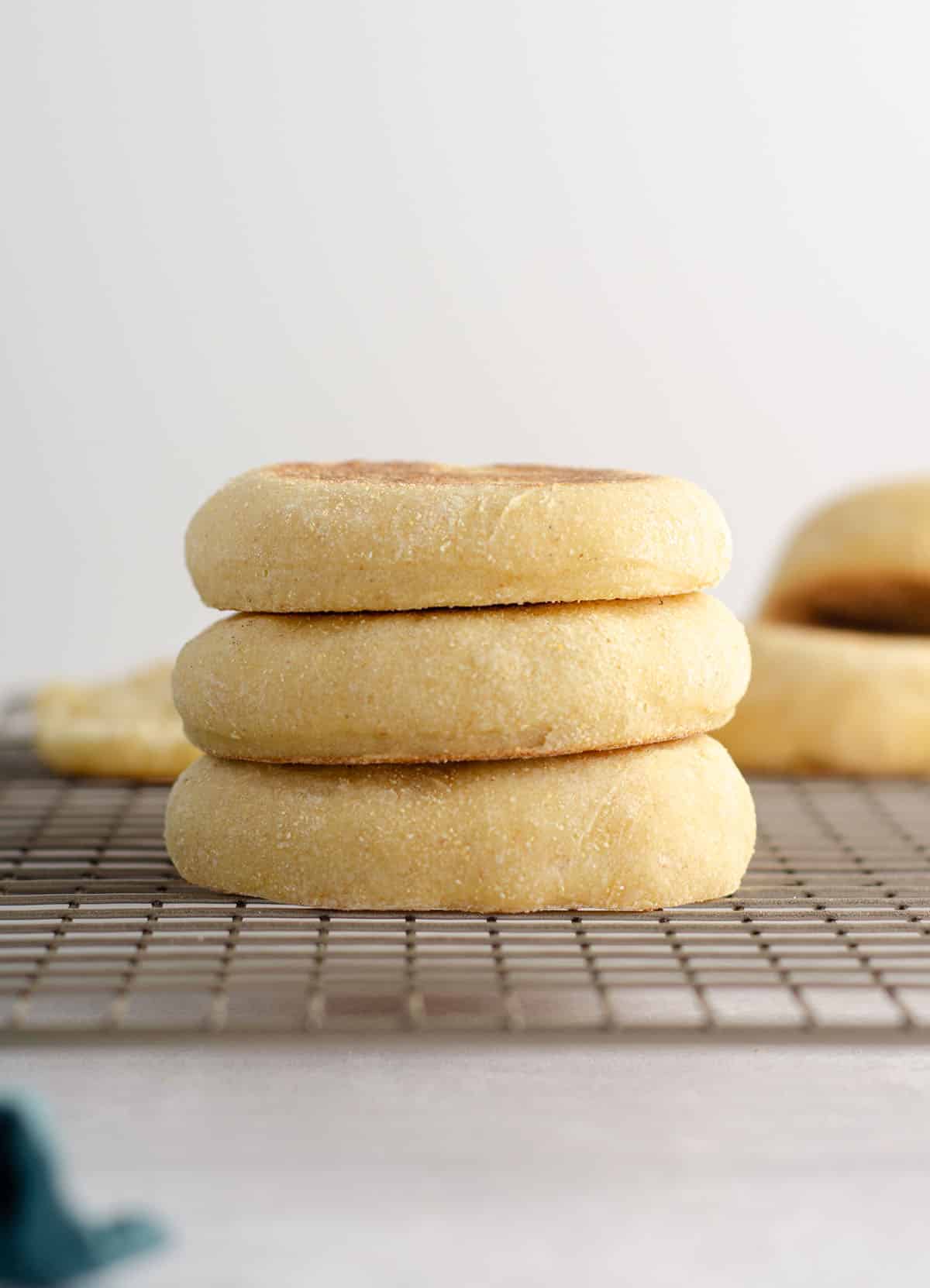 stack of sourdough english muffins on a cooling rack