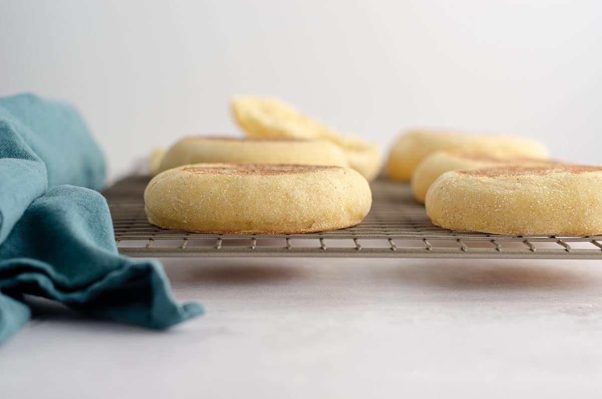 sourdough english muffins on a cooling rack