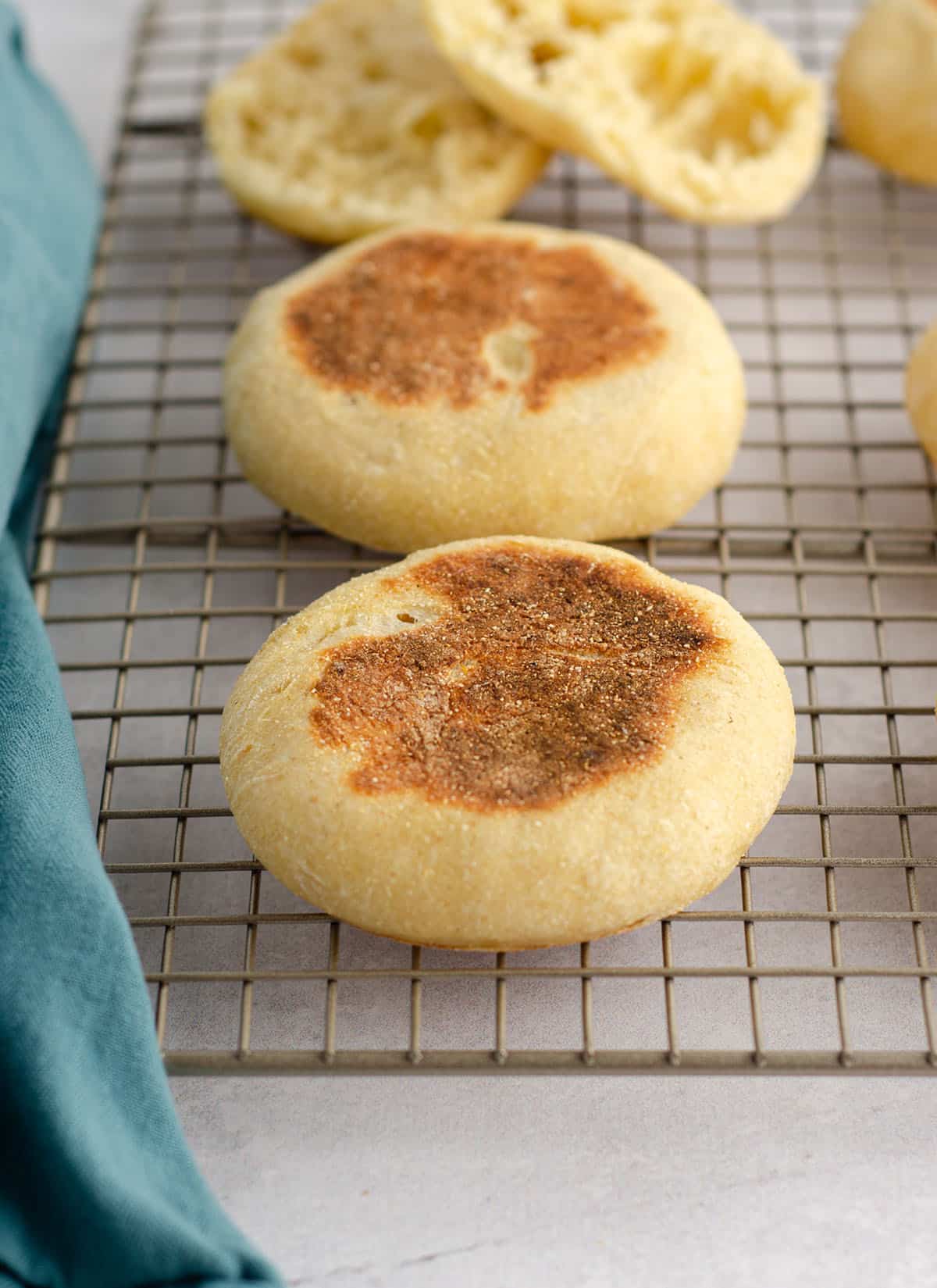 sourdough english muffins on a cooling rack