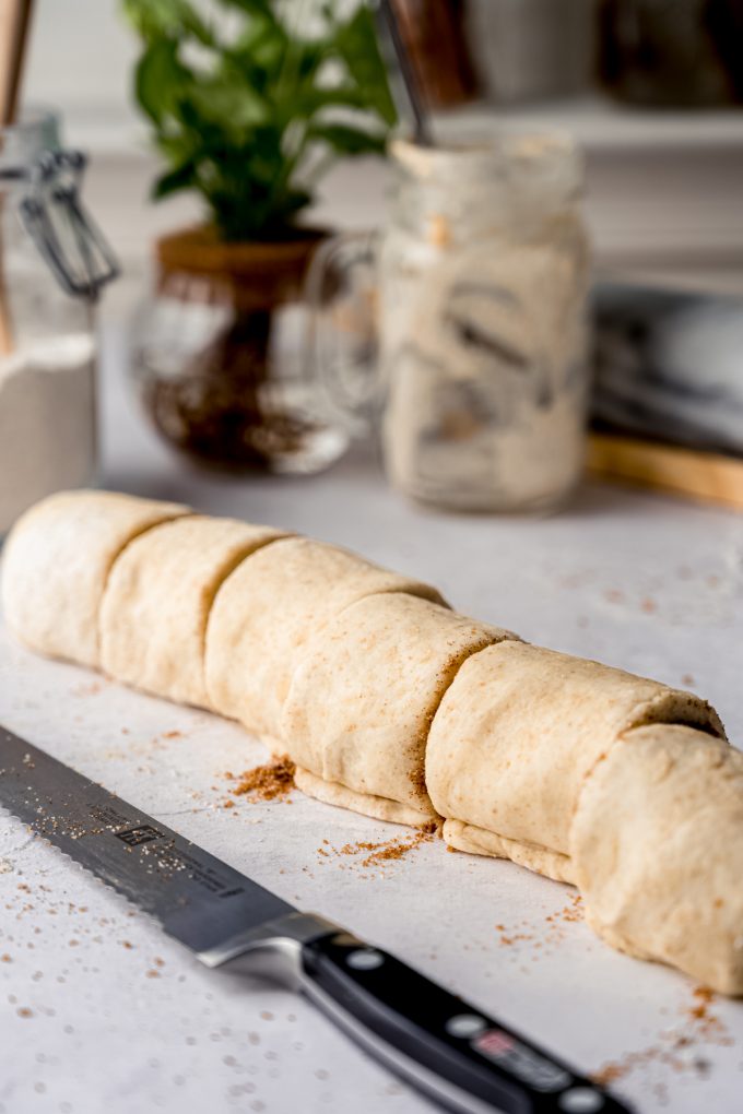 A log of cinnamon rolls into individual rolls.