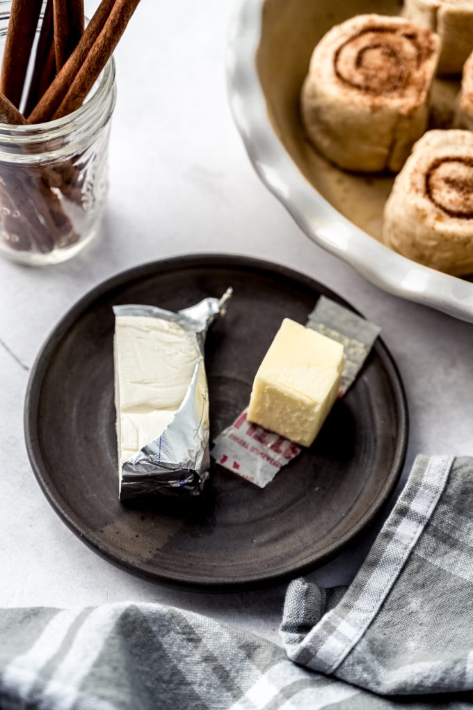 A plate with cream cheese and butter on it.