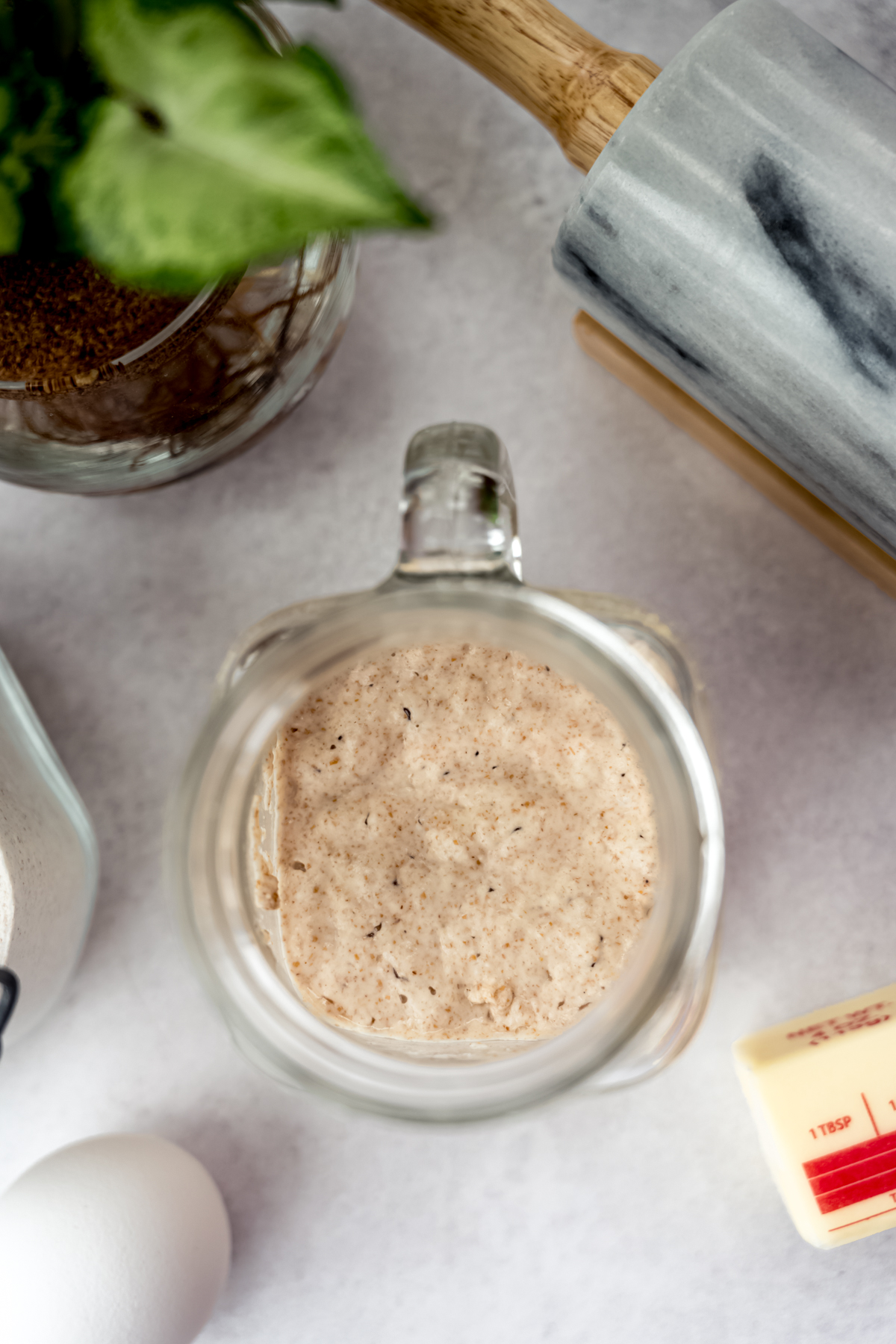 Aerial photo of a jar of active bubbly sourdough starter.