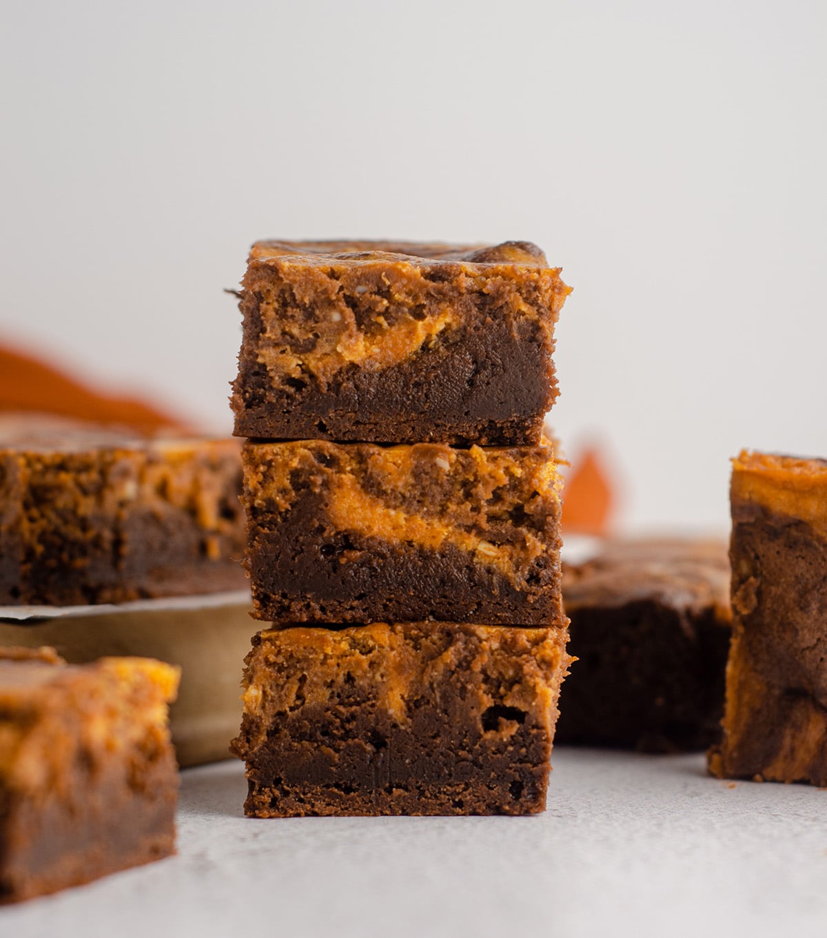 stack of pumpkin cheesecake brownies