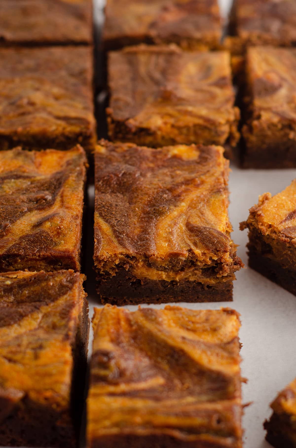 sliced pumpkin cheesecake brownies