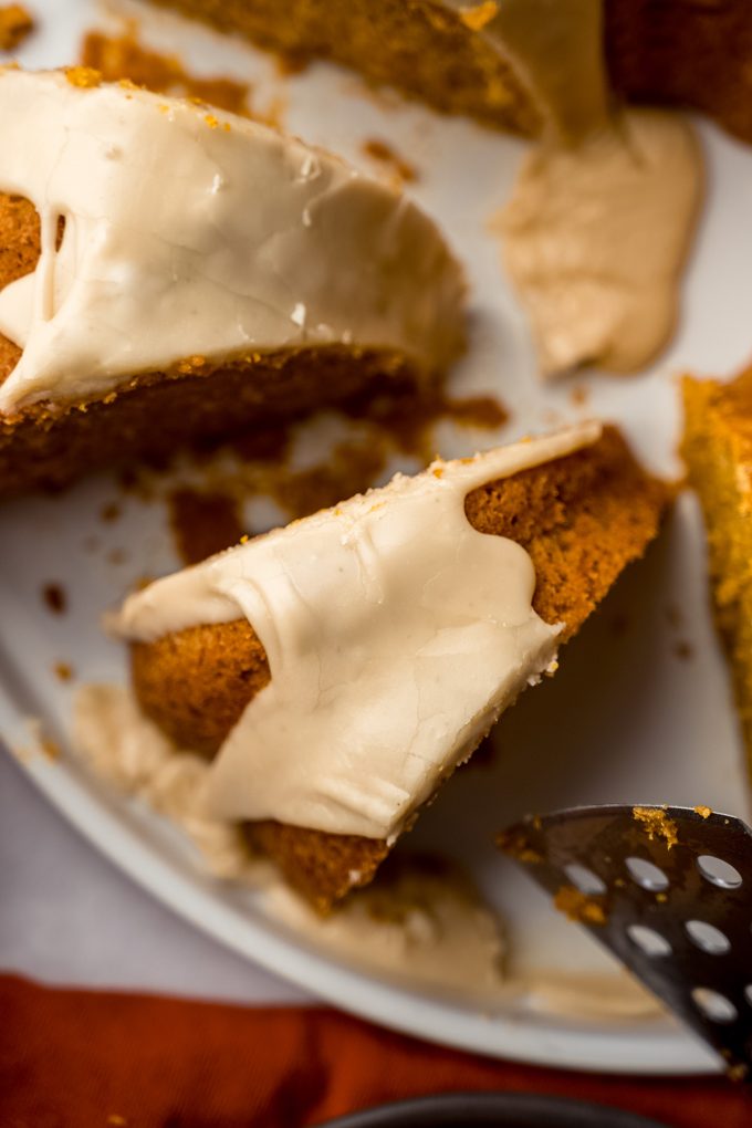 Aerial photo of a slice of pumpkin Bundt cake sitting on a platter.