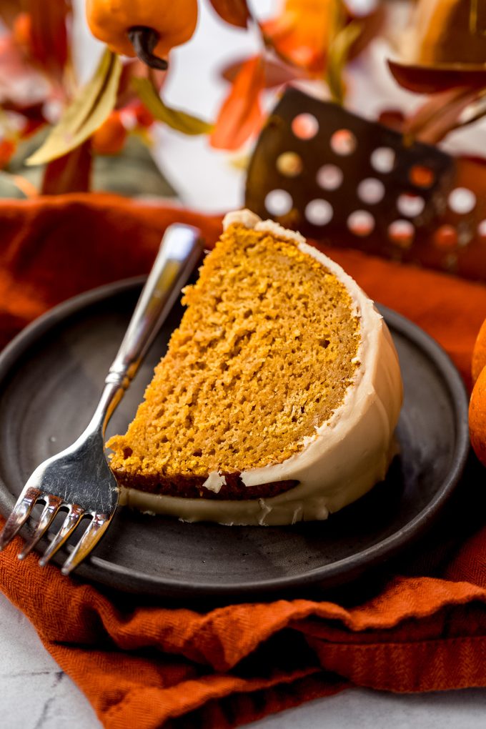A slice of pumpkin Bundt cake on a plate with a fork.