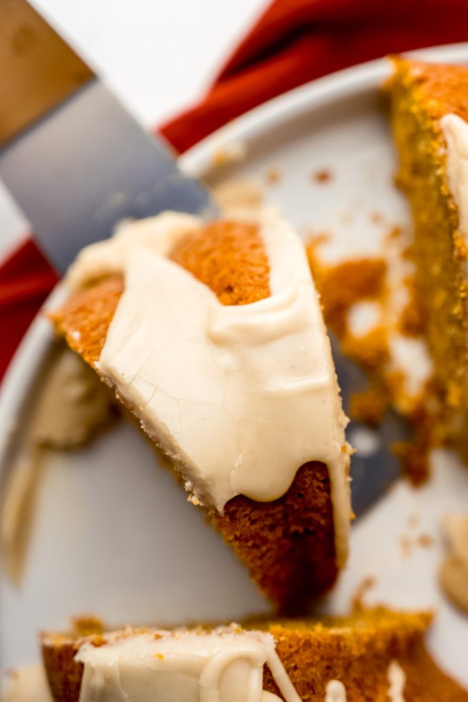 Aerial photo of a slice of pumpkin Bundt cake sitting on a platter.