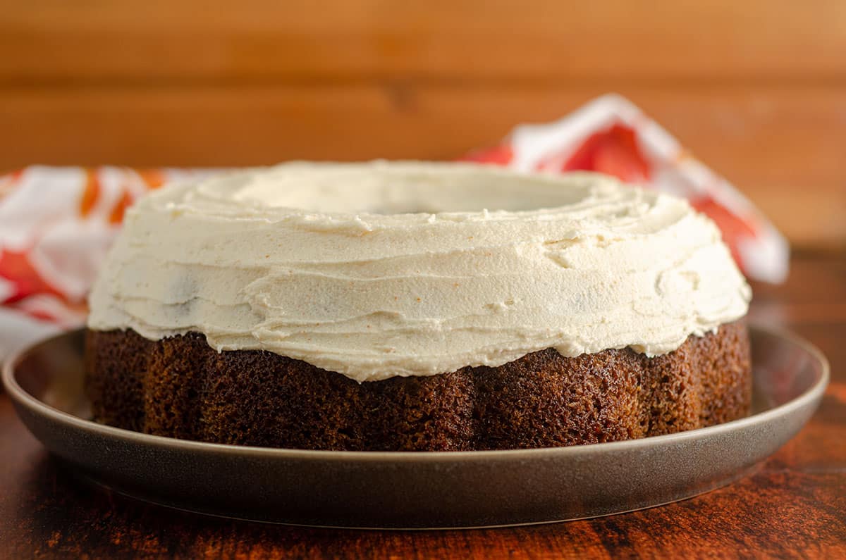 pumpkin bundt cake with browned butter buttercream sitting on a plate