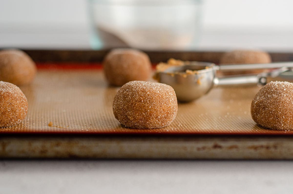 balls of pumpkin spice cookie dough on a baking sheet