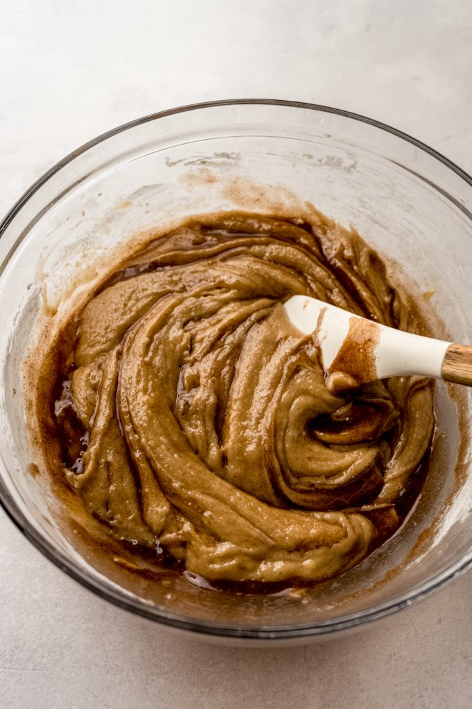 A bowl of snickerdoodle cookie cake batter in a big bowl with a spatula.