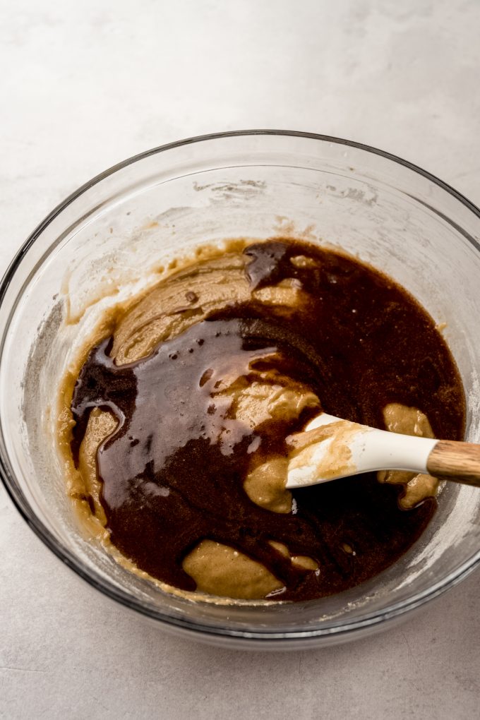 A bowl of snickerdoodle cookie cake batter in a big bowl with a spatula.