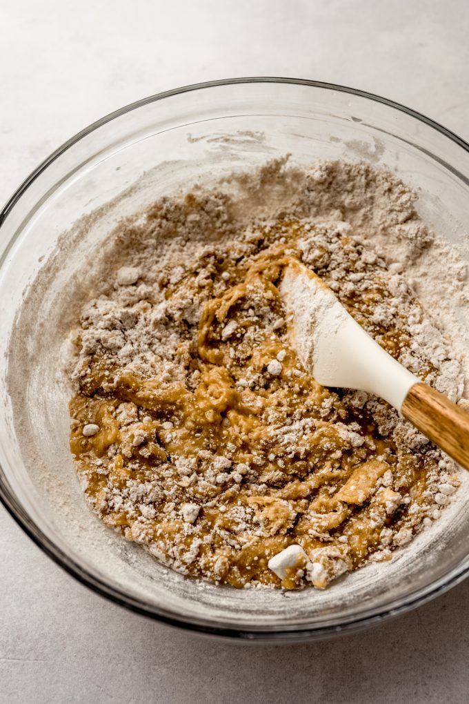 A bowl of snickerdoodle cookie cake batter in a big bowl with a spatula.