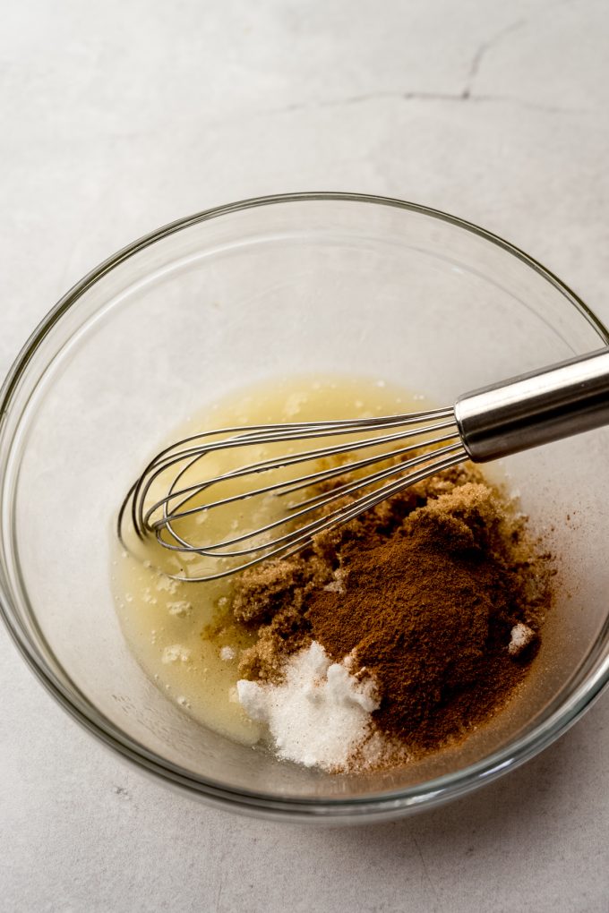 The cinnamon mixture for snickerdoodle cookie cake in a bowl with a whisk.
