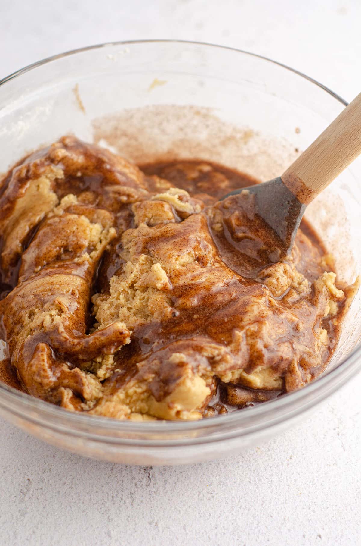 snickerdoodle cookie cake in a bowl with a spatula