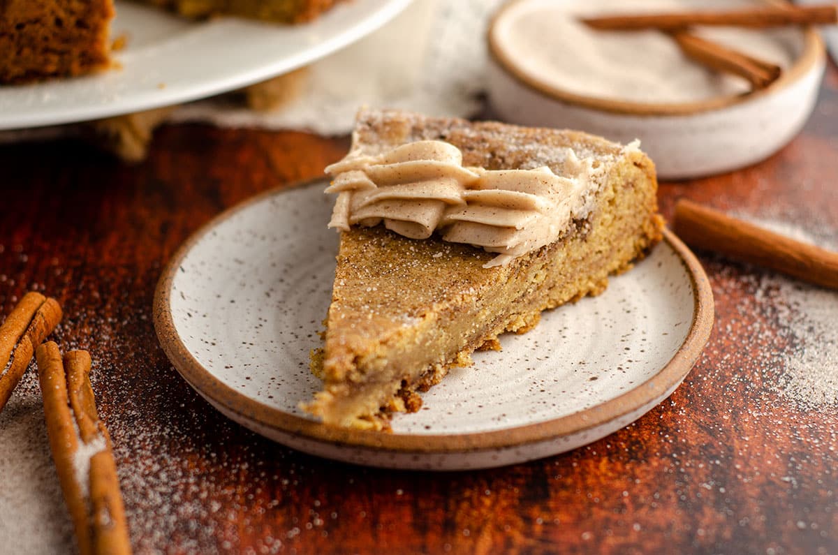 snickerdoodle cookie cake sitting on a ceramic plate