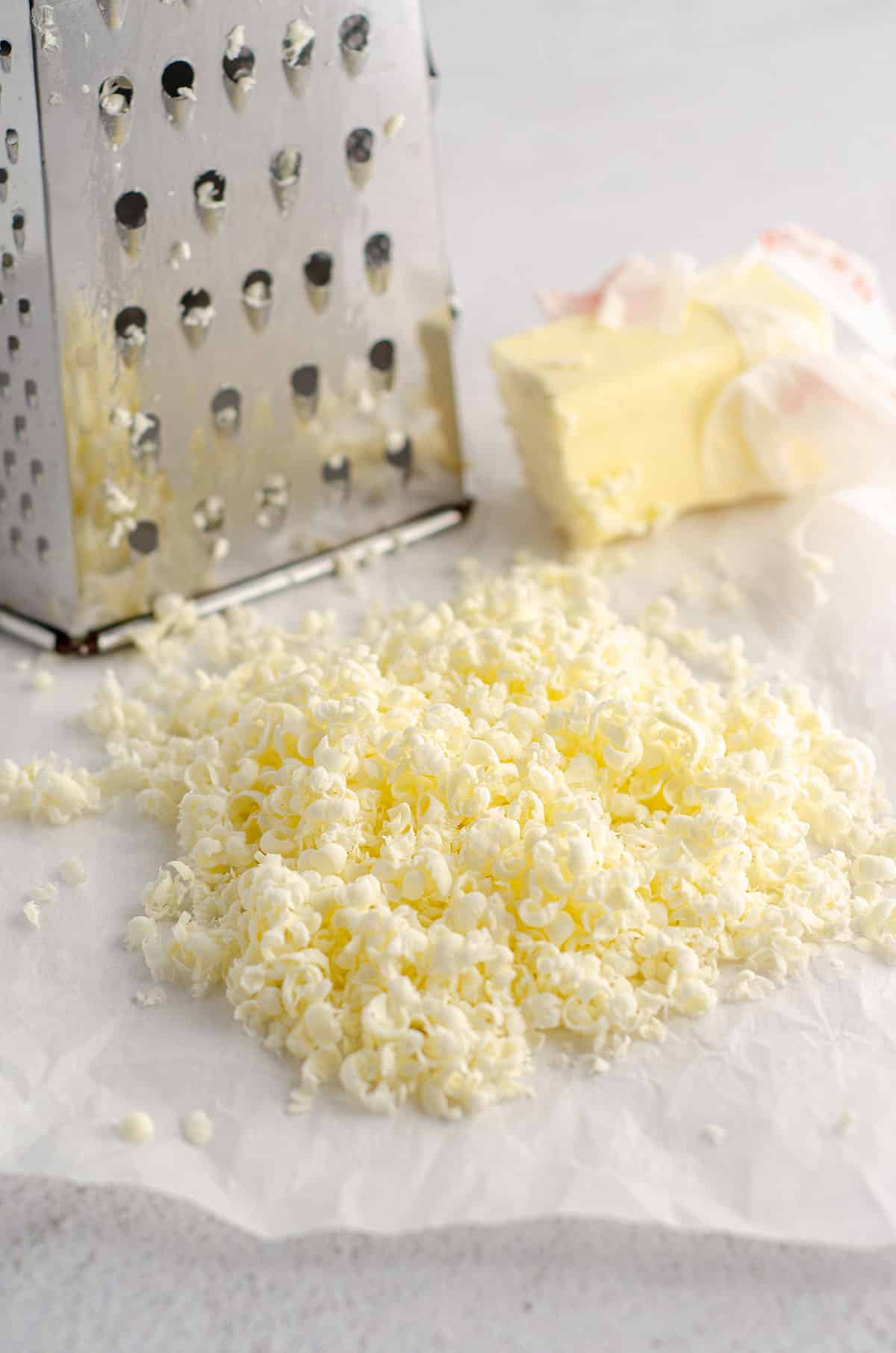 frozen butter grated with a box grater in background