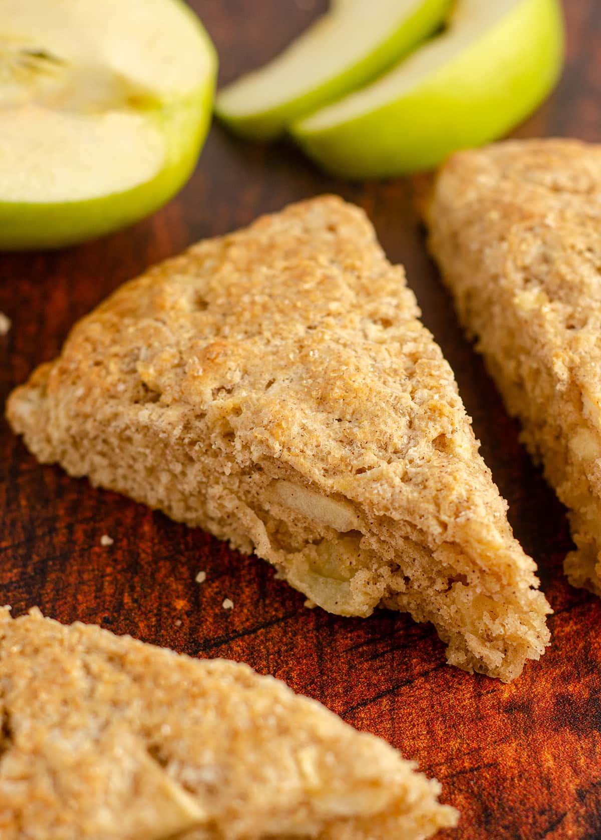 an apple scone with granny smith apple slices in background