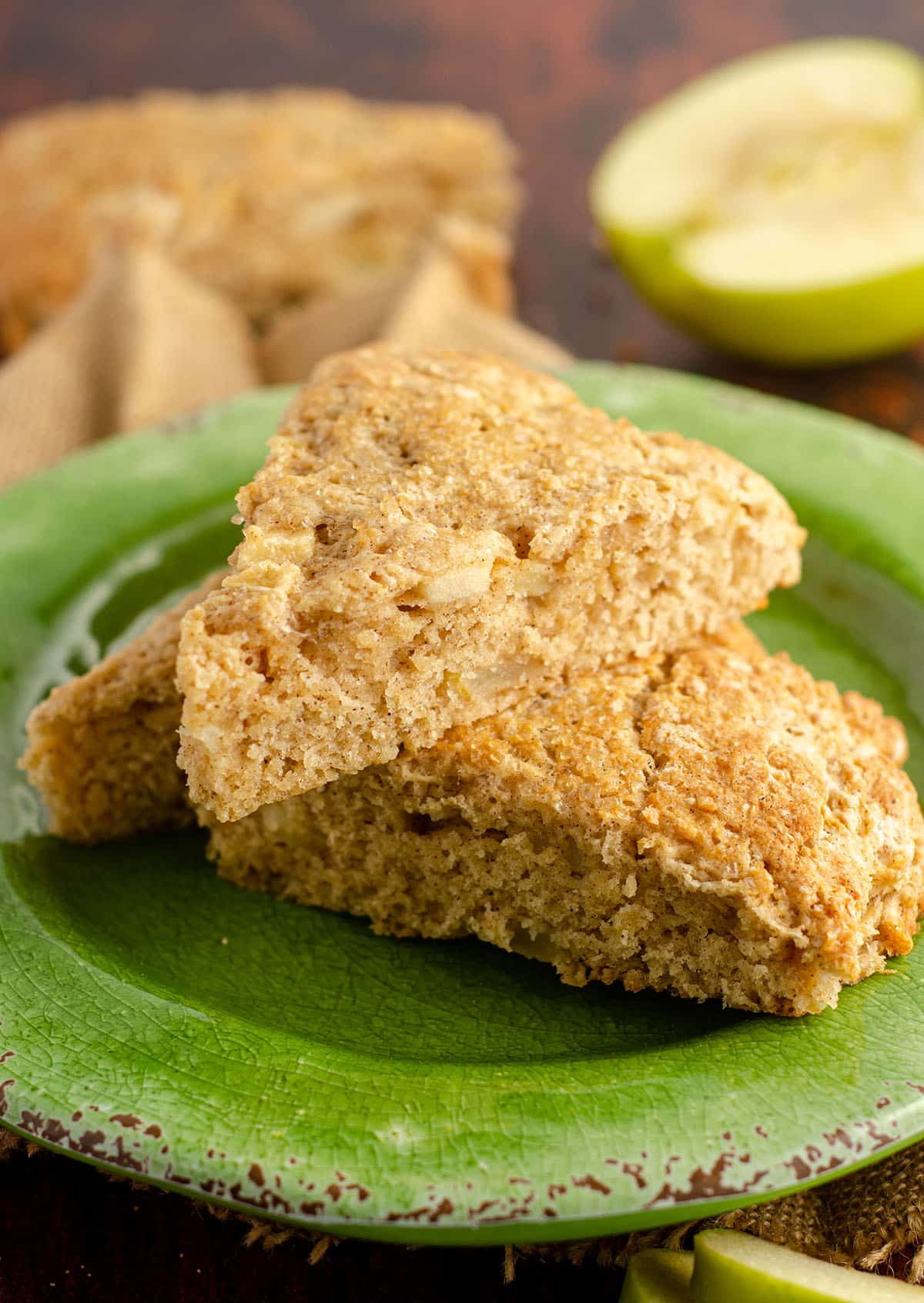 three apple scones piled up on a green plate