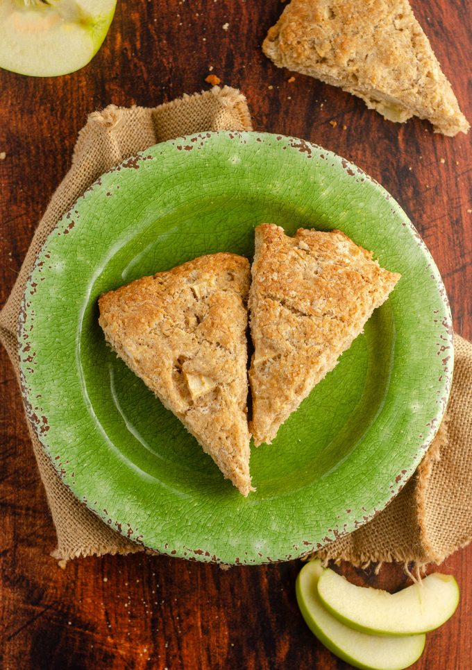 aerial view of apple scones on a green plate with burlap cloth