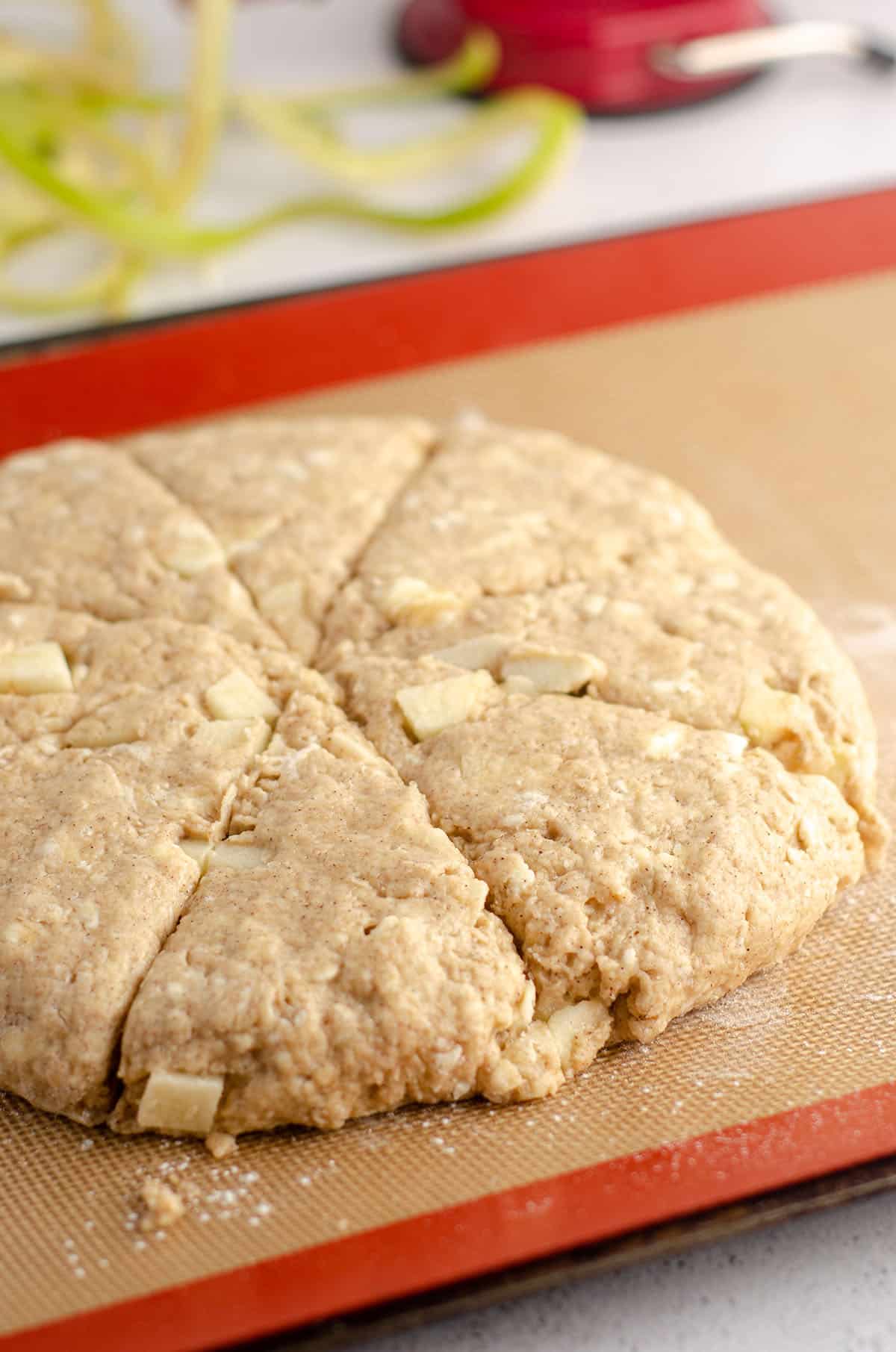 apple scones sitting on baking sheet ready to bake