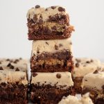 stack of 3 cookie dough brownies with cookie dough buttercream