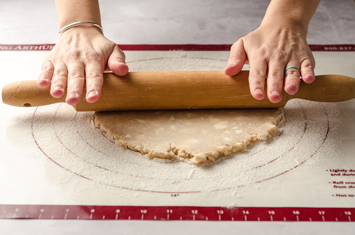 rolling out a pie crust with a rolling pin