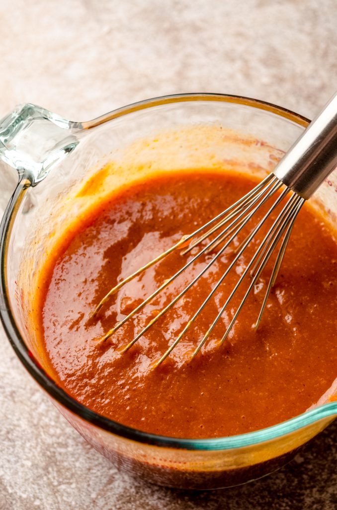 The ingredients for pumpkin pie in a large glass measuring cup after mixing together.