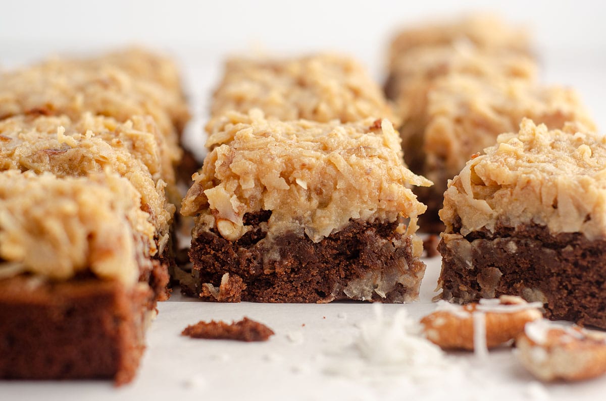 german chocolate brownies with pecans and coconut scattered around