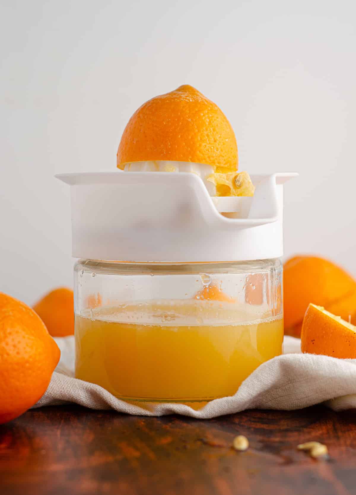 meyer lemon half sitting on top of a citrus juicer filled with meyer lemon juice