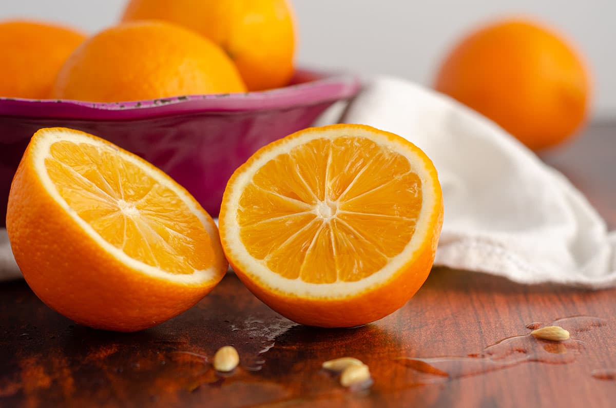 sliced meyer lemon with juice and seeds spilling out