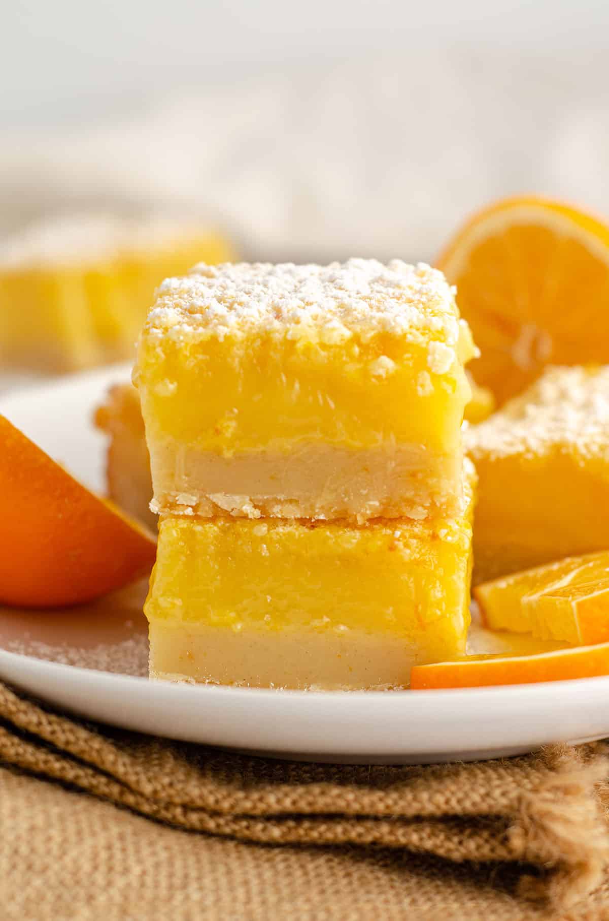 stack of meyer lemon bars with slices of meyer lemon