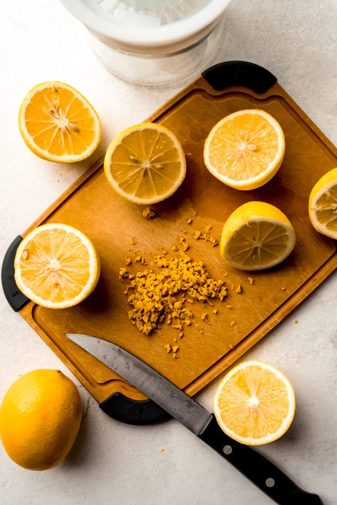 Aerial photo of a cutting board with Meyer lemons and zest on it.