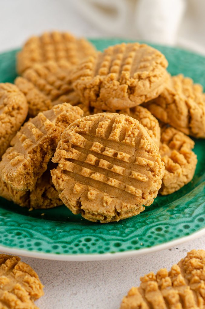 vegan and gluten-free peanut butter cookies sitting on a turquoise plate