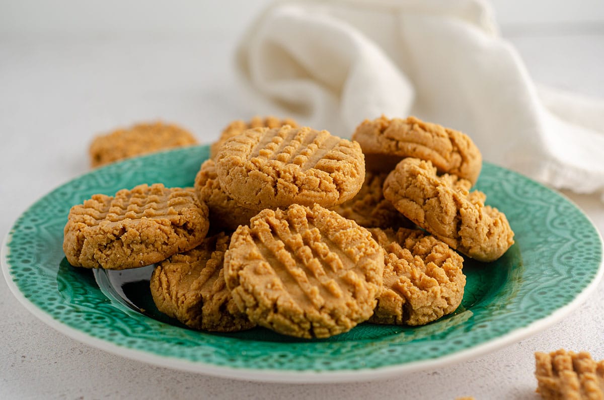 vegan and gluten-free peanut butter cookies sitting on a turquoise plate