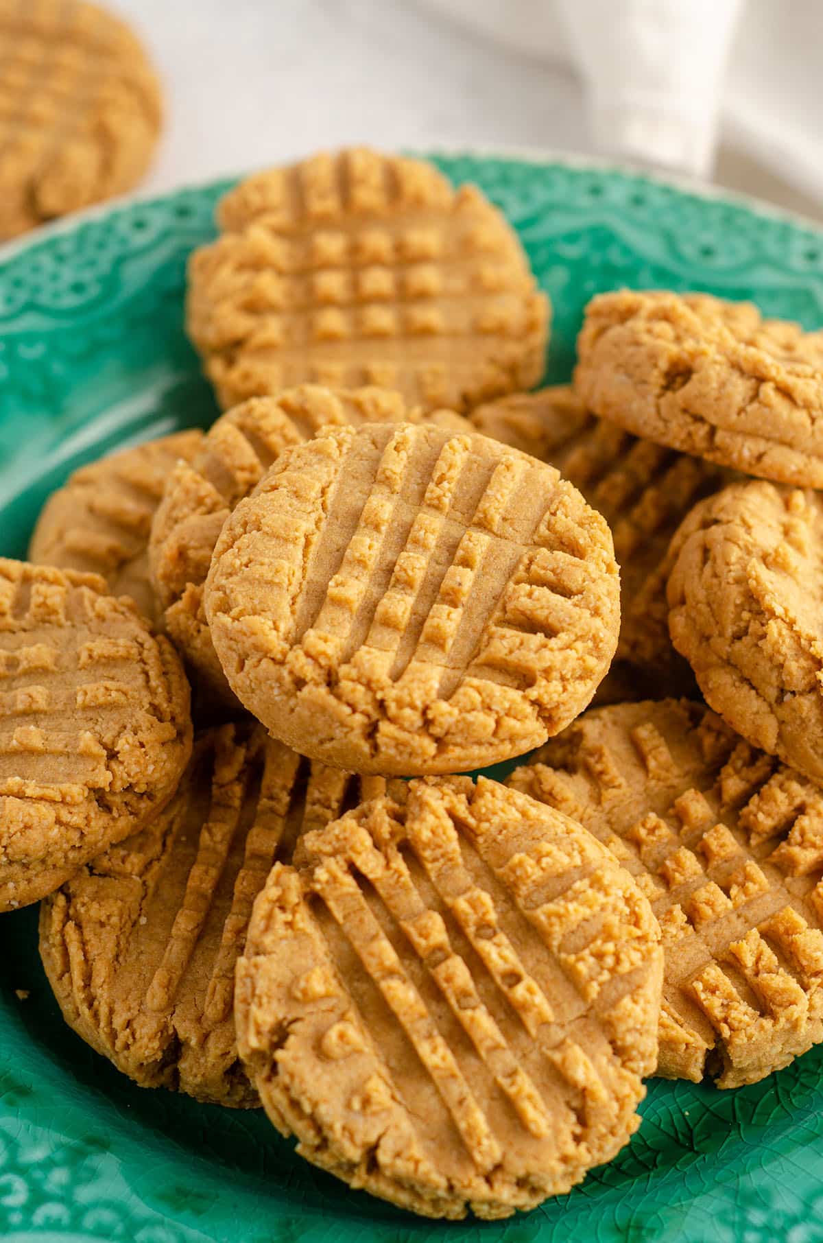 vegan and gluten-free peanut butter cookies sitting on a turquoise plate