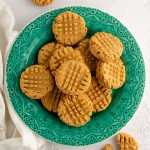 aerial photo of vegan and gluten-free peanut butter cookies sitting on a turquoise plate