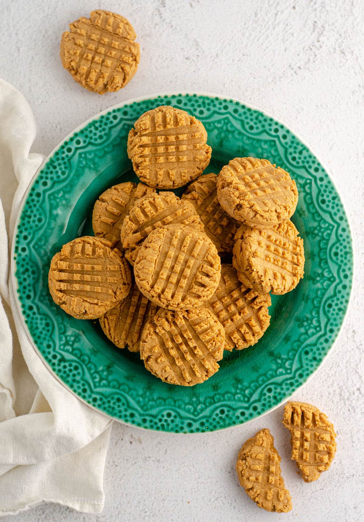 aerial photo of vegan and gluten-free peanut butter cookies sitting on a turquoise plate