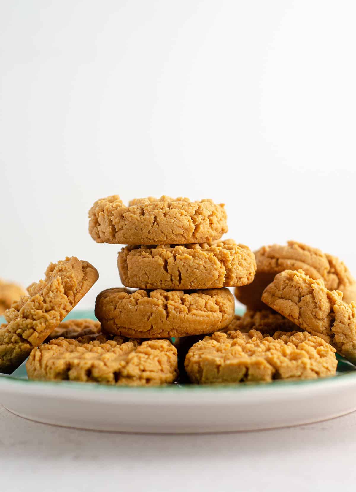 vegan and gluten-free peanut butter cookies sitting on a turquoise plate