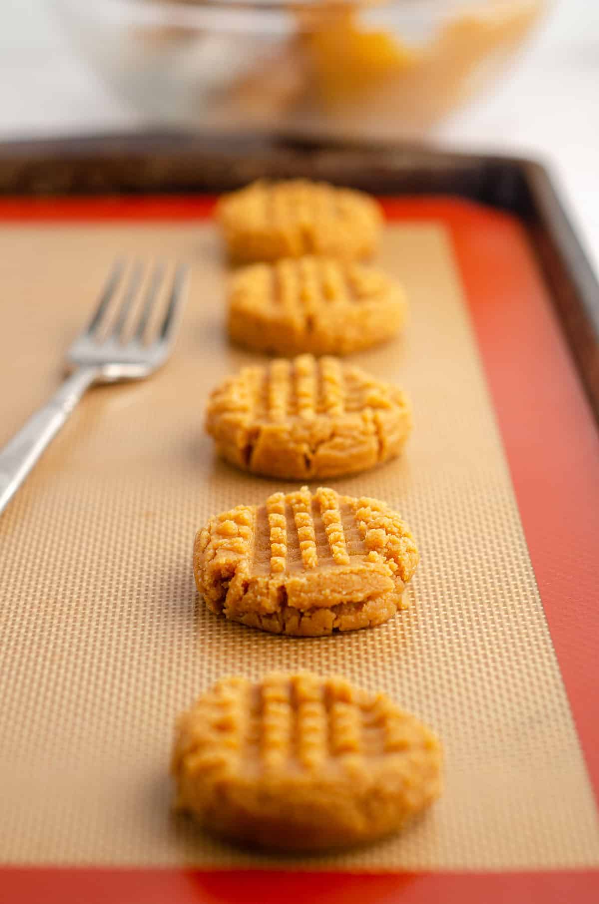 vegan and gluten-free peanut butter cookies on a baking sheet ready to bake