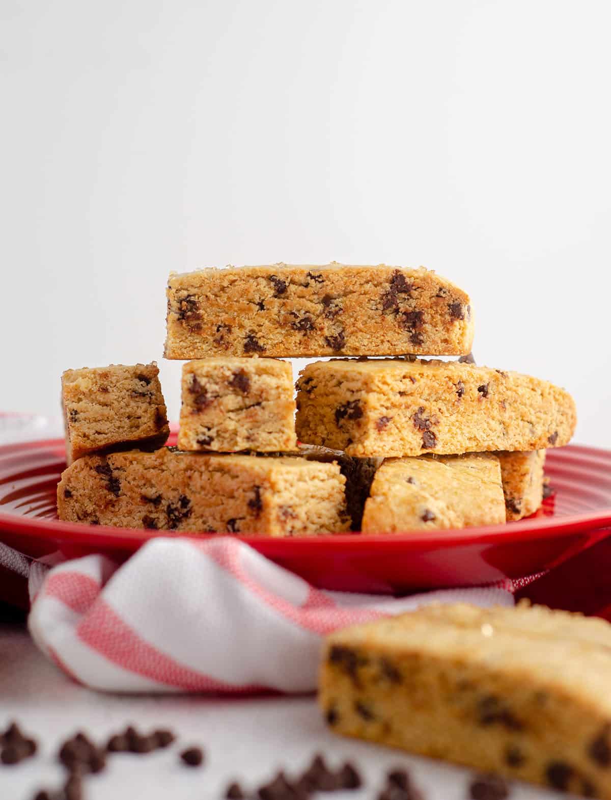 chocolate chip biscotti stacked on a red plate