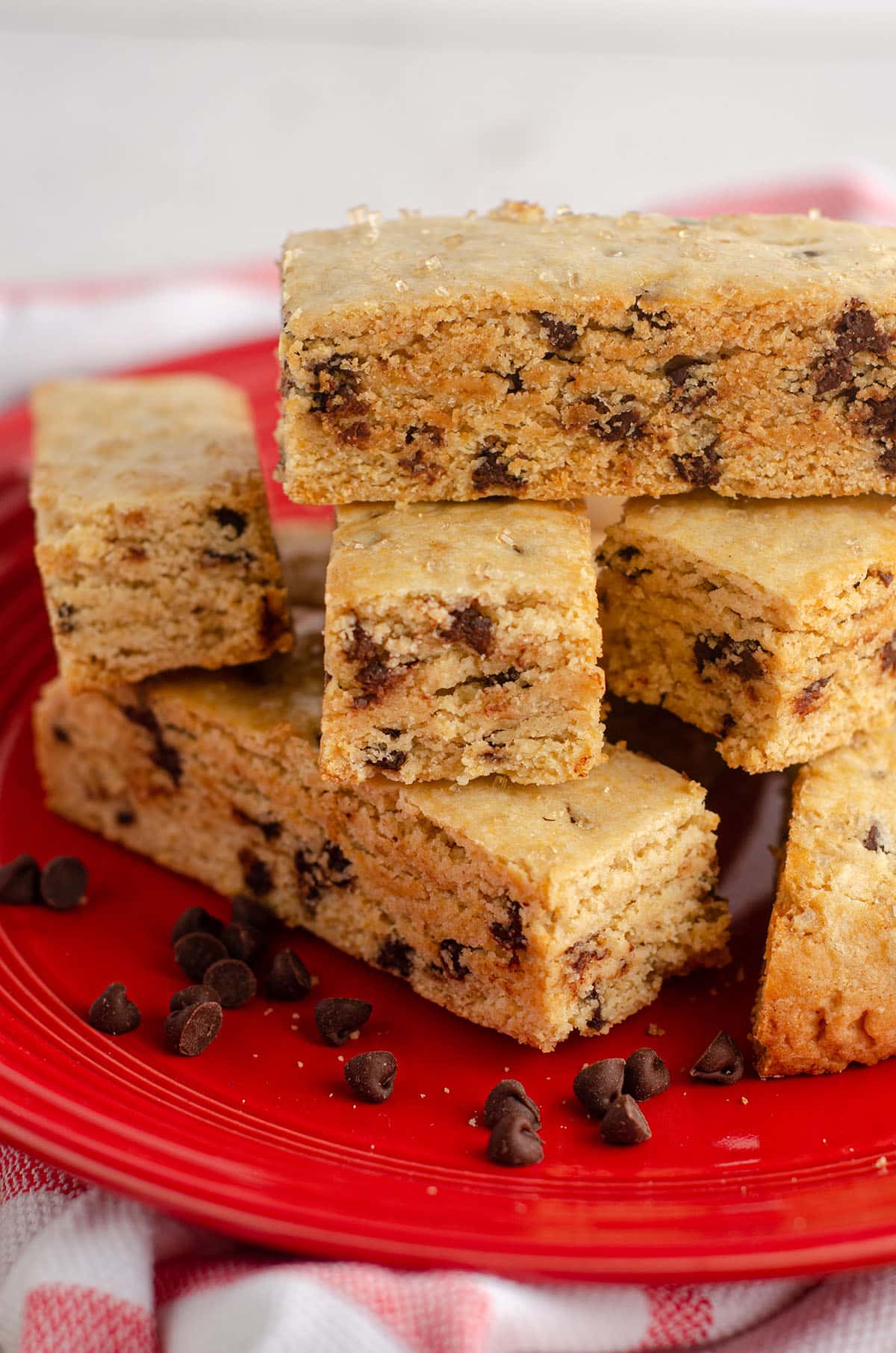 chocolate chip biscotti stacked on a red plate