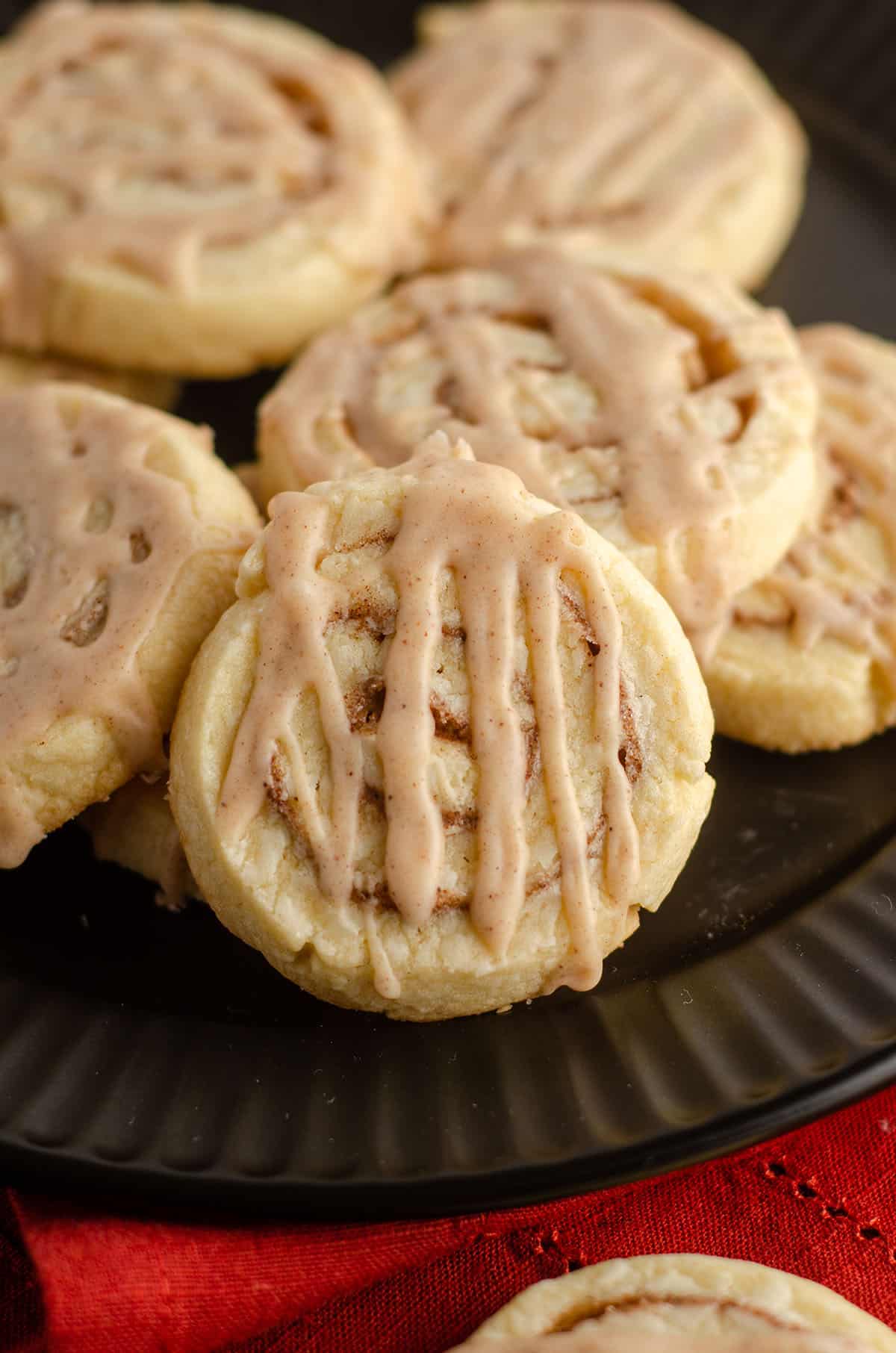 cinnamon pinwheel cookies sitting on a black plate