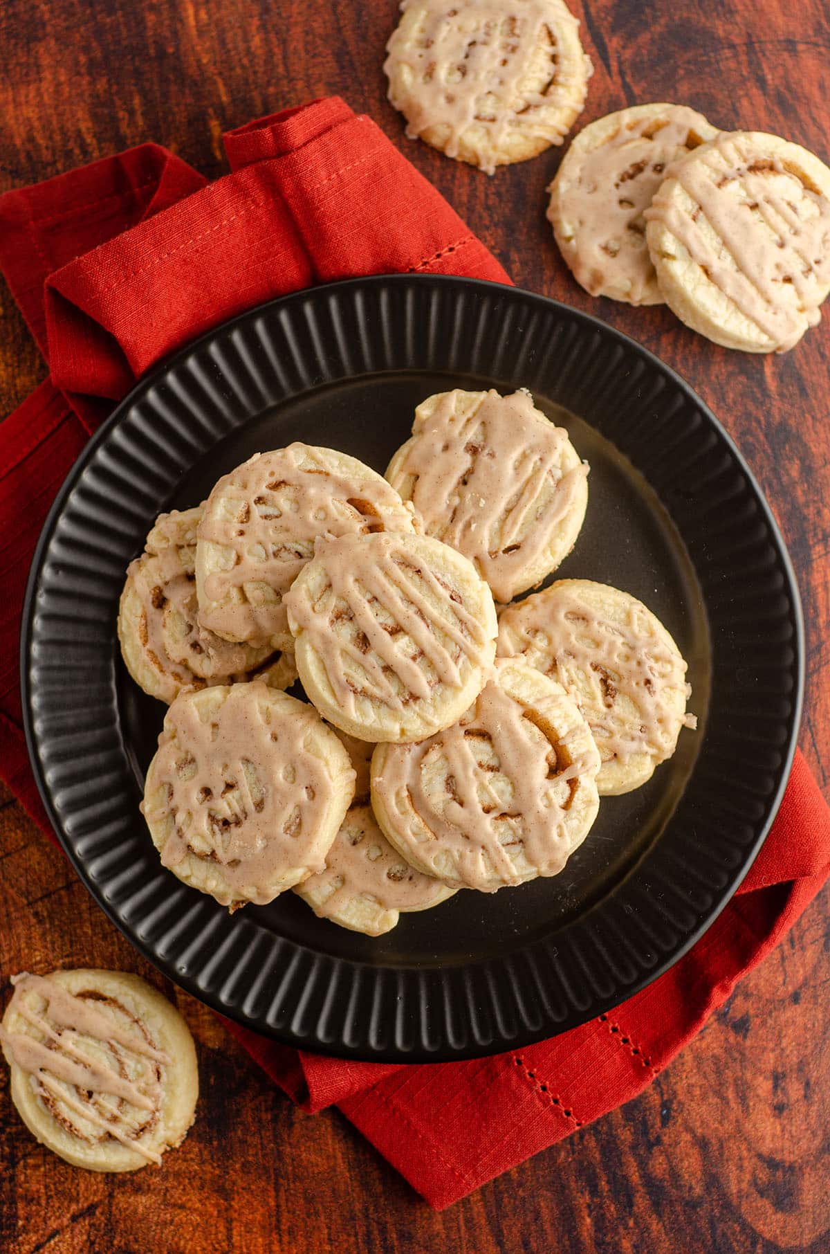 aerial photo of cinnamon pinwheel cookies sitting on a black plate