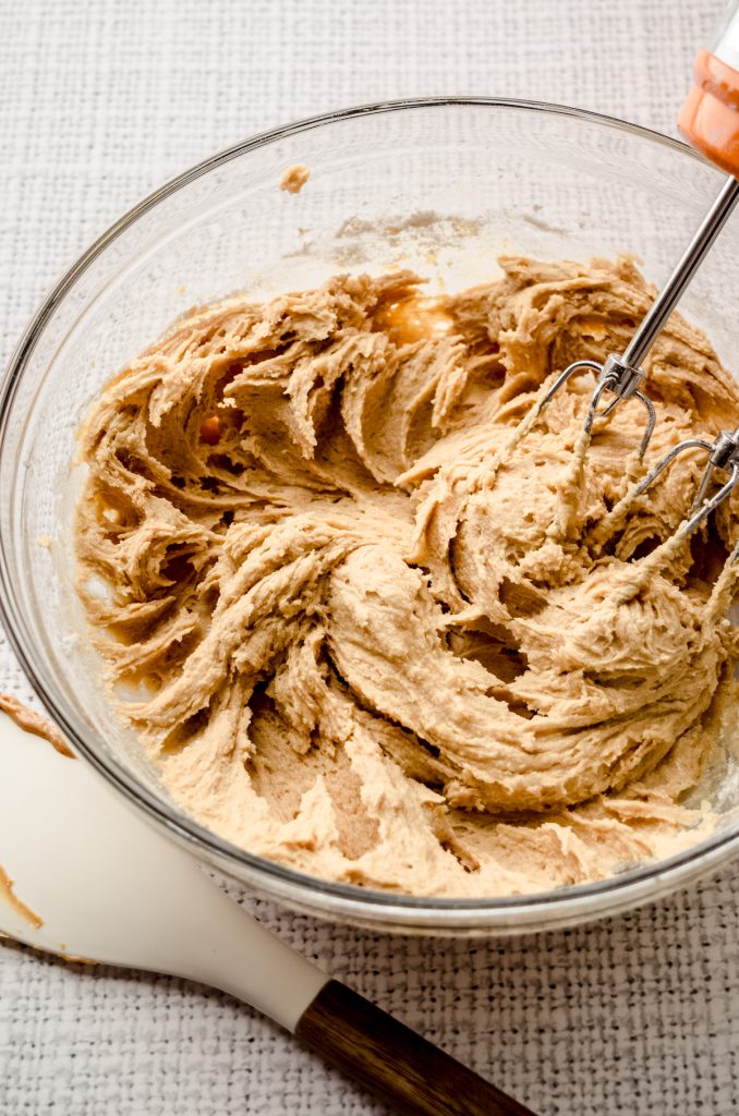 A bowl of ingredients mixed to make peanut butter Rolo cookies.