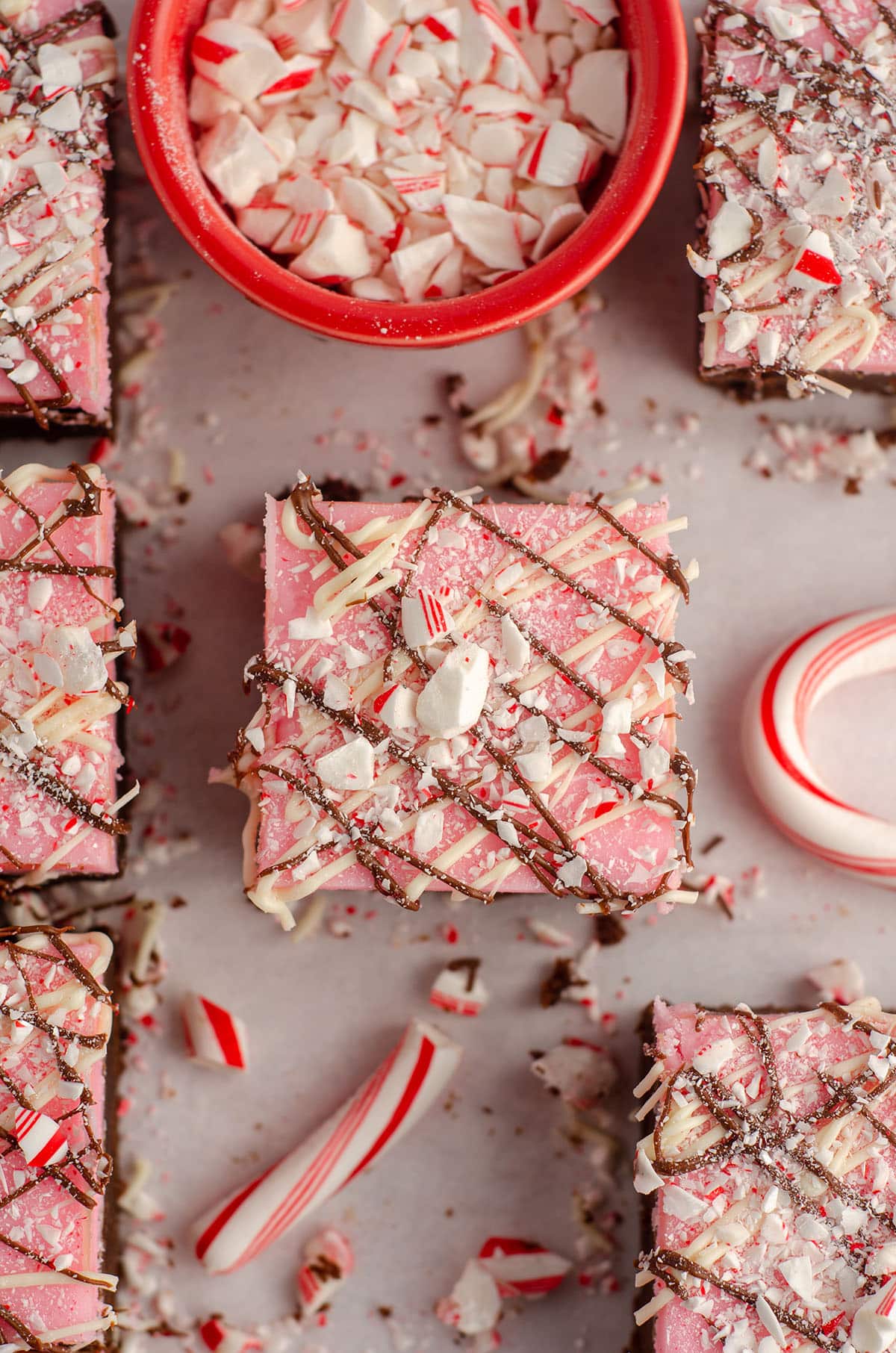 aerial photo of peppermint brownie sitting in front of a red prep bowl filled with crushed candy canes