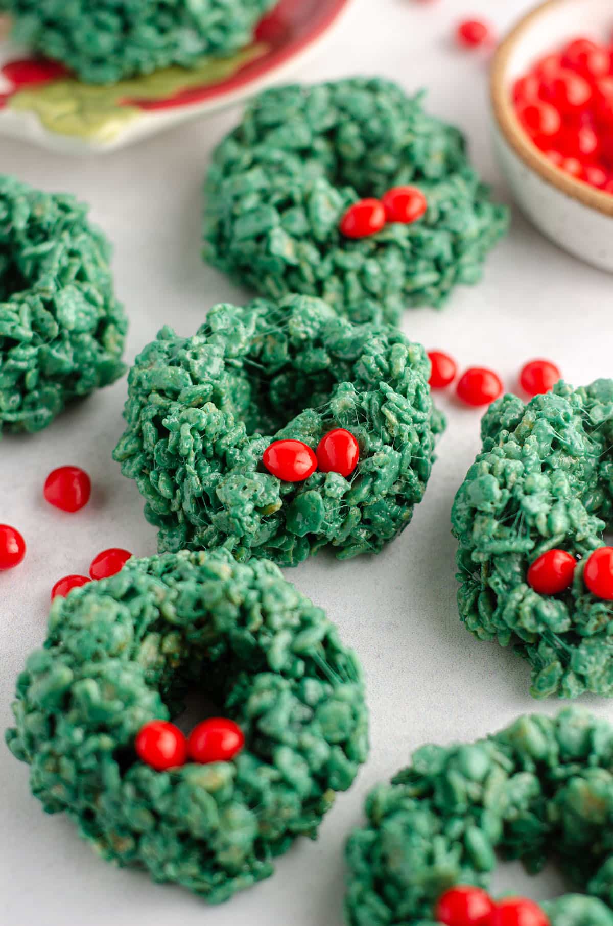 rice krispies wreaths with red candies scattered around