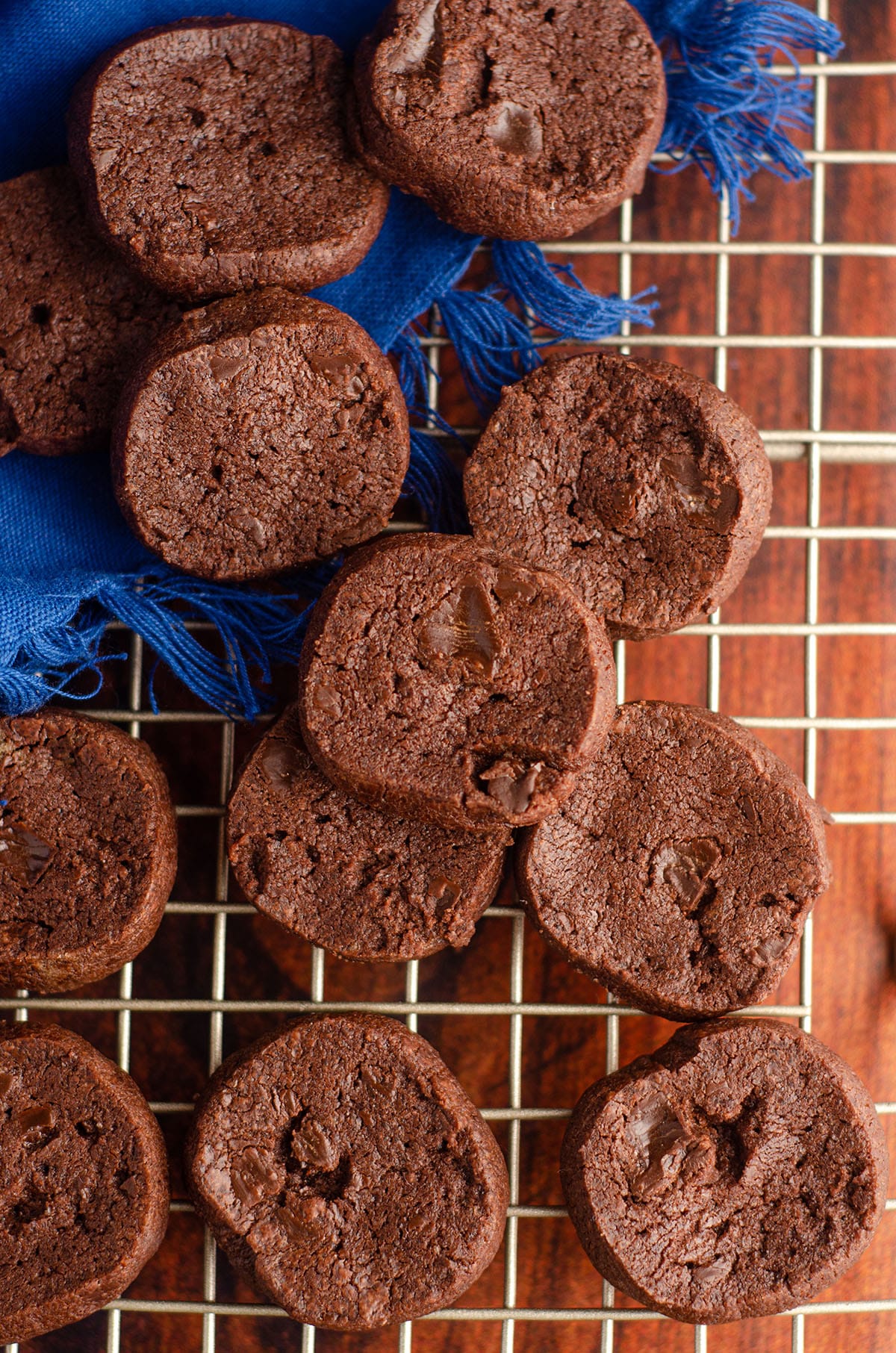 aerial photo of dorie greenspan's world peace cookies on a wire cooling rack with a blue kitchen towel