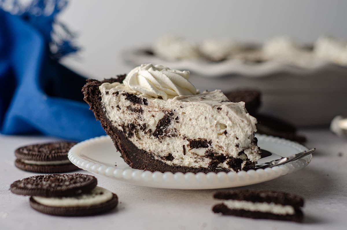 side view of slice of no bake oreo pie sitting on a plate