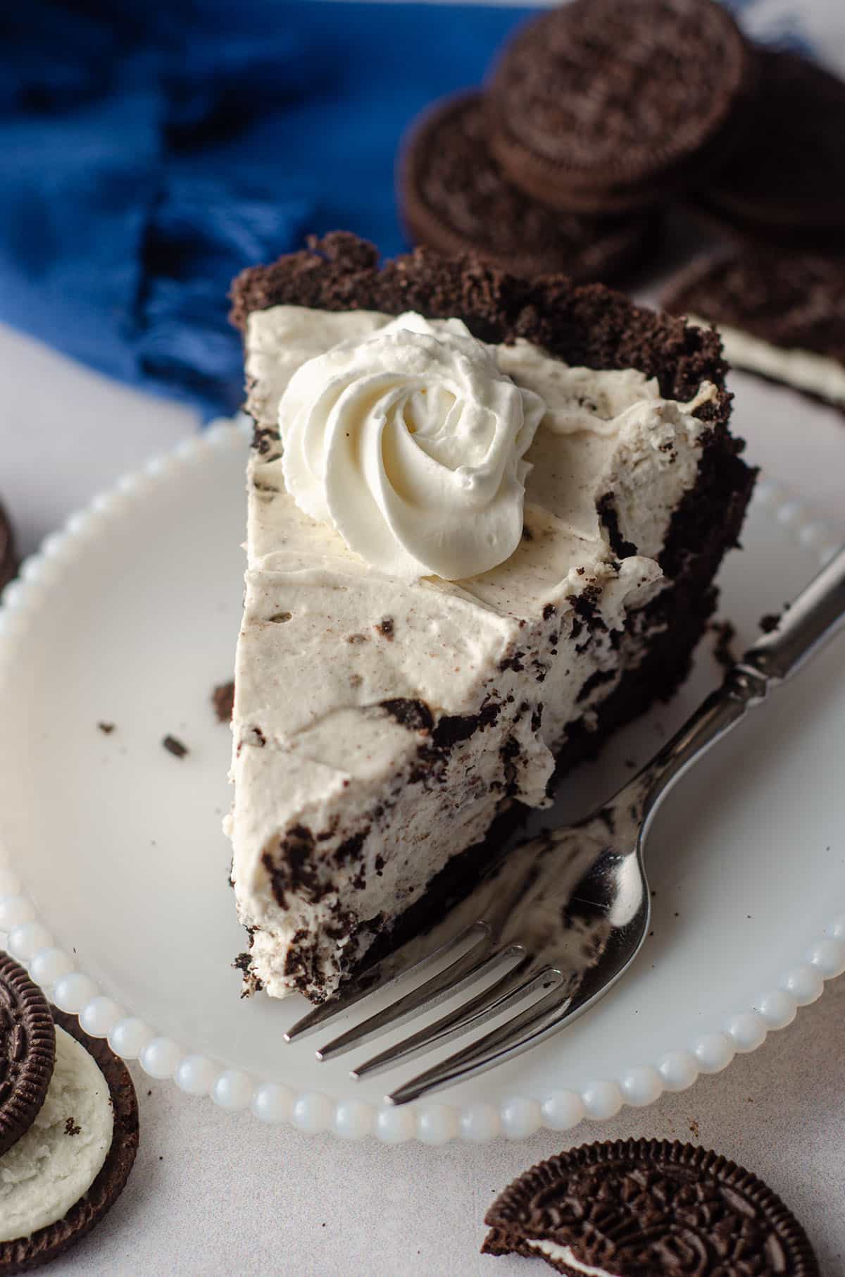 slice of no bake oreo pie sitting on a plate with a fork